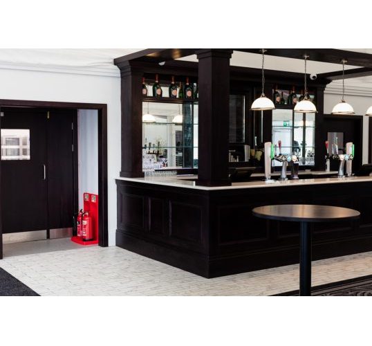 Double fire extinguisher stand in a commercial bar setting